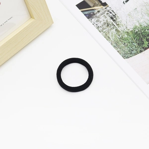 Detail of high-elastic black seamless hair ties on white background with minimalist decor