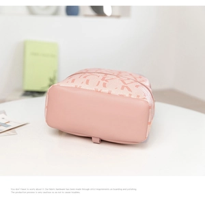 Close-up of pink PU leather base and letter jacquard fabric on the stylish backpack
