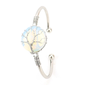 Close-up of silver wire-wrapped Tree of Life design on a crystal stone bangle
