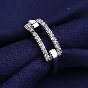 Minimalist double layer silver ring with small zircons on navy blue velvet background