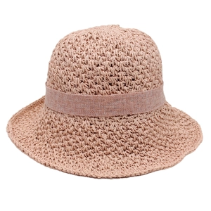 Close-up of beige hand-woven straw hat showing detailed crochet texture and ribbon trim