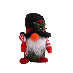 Christmas gnome doll with red plaid hat, white beard and candy cane on white background