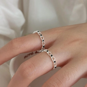 Close-up of 925 sterling silver hollow heart ring with black zircon stones