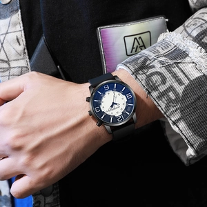 Men's quartz watch with black silicone strap and numeric dial worn by a model