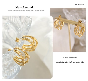 Detailed view of gold multi-layer C-shaped hoop earrings with inlaid white zircon accents