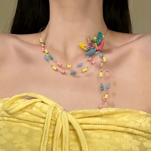 Close-up view of a colorful multi-strand dopamine glass beaded flower necklace on a model