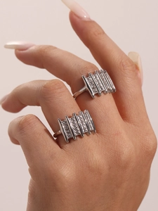 Detail of silver zircon ring on finger showing sparkling micro-pave geometric metal bars