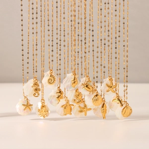 Detail of 18K gold starfish and seahorse pendants with shell on stainless steel chains