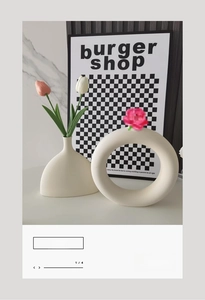 Minimalist matte ceramic vases in donut and organic shapes with tulip floral arrangement