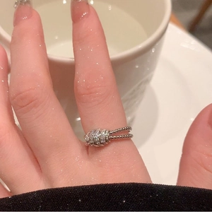 Detail of silver twisted band ring with sparkling zircons on model's hand