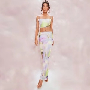 Detailed view of women's two-piece set featuring abstract tie-dye print and pleated texture
