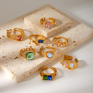 French vintage stainless steel rings with colorful zircon on travertine stone