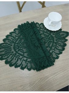 Close-up of a dark green oval cotton lace table runner with intricate crochet details