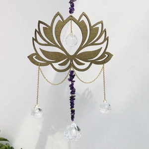 Detail of wooden golden lotus suncatcher with amethyst stones and crystal prism ball
