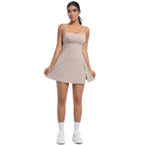 Detail view of the side slit and elastic fabric on this beige athletic mini dress