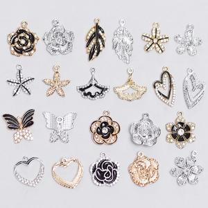 Assorted gold and silver alloy DIY pendants with rose, heart, and starfish designs