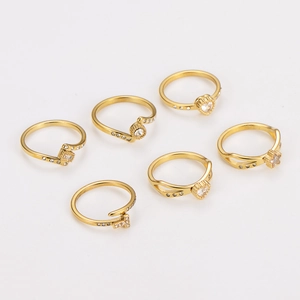 6-piece gold stainless steel ring set with zircon stars and hearts on white background