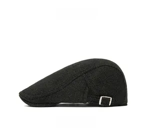 Side view of dark herringbone flat cap featuring adjustable silver metal side buckles