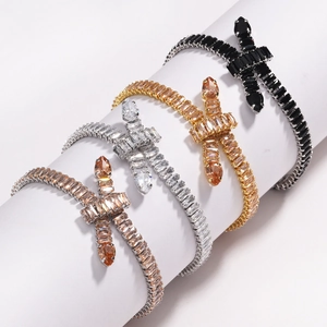 Macro shot of colorful tennis bracelets with zirconia cross and bow knots in four plating finishes