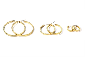 Detailed set of three polished gold hoop earrings in small, medium, and large sizes