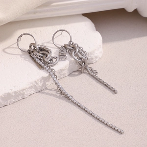 Detail shot of silver fringe earrings with shimmering zircon and metallic chains