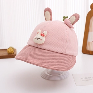 Detailed texture of pink corduroy kids bucket hat with 3D bunny ears and patches
