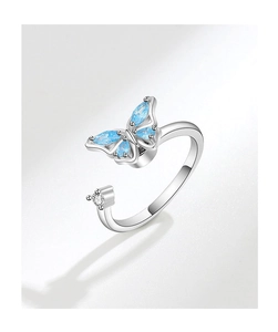 Detailed macro view of silver butterfly ring with blue marquise gemstones and open band