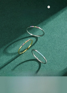 Macro detail of slim S925 silver rings with turquoise and rainbow zircon inlay