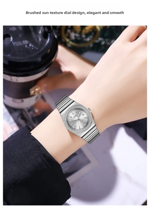Close-up of GEDI women's watch with rhinestone bezel and silver sunray dial on wrist