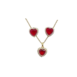 Gold jewelry set featuring red heart pendant necklace and matching stud earrings on white
