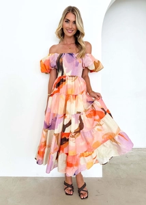 Detail of off-shoulder puff sleeves and tiered colorful abstract print maxi dress