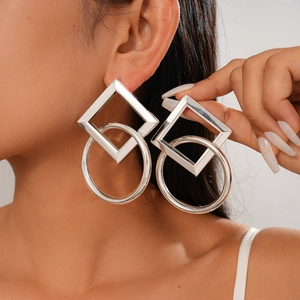 Silver geometric interlocking square and circle earrings on professional model
