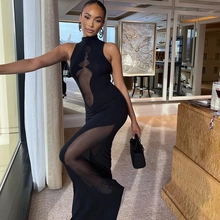 Close-up of sheer mesh splicing and high neck detail on a slim fit black dress