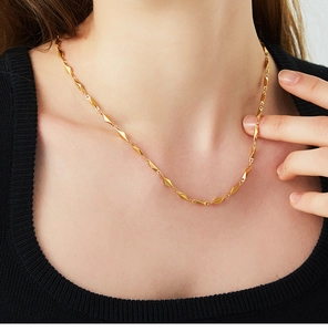 Close-up of geometric diamond links on an 18K gold plated stainless steel necklace