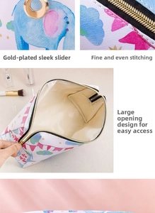 Detail of circus print makeup bag featuring gold ring zipper and waterproof PU material