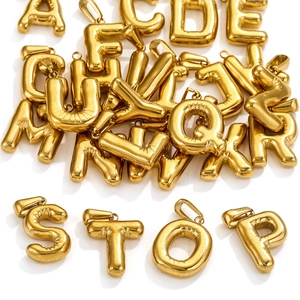 Detailed view of 18K gold plated stainless steel bubble letter charms spelling STOP