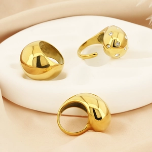 Chunky 18K gold plated stainless steel open rings with zircon inlay on warm beige fabric