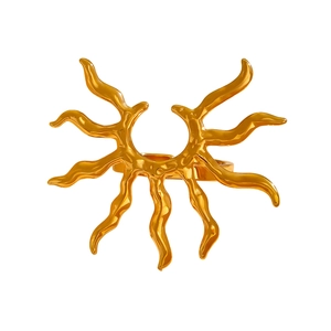 Detailed view of the wavy sunburst design and glossy gold texture of the stainless steel ring