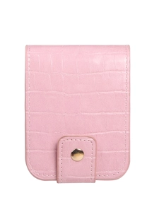 Pink faux crocodile leather mini lipstick case with a golden metal clasp on white background