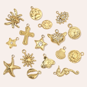 Collection of 15 gold-plated stainless steel charms with stars, shells and sea horses