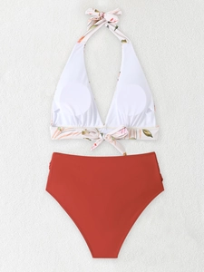 Detail of high waisted two-piece bikini featuring floral halter top and brick red bottoms