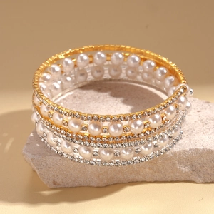 Elegant multi-layer pearl and rhinestone cuff bracelet with a golden finish base