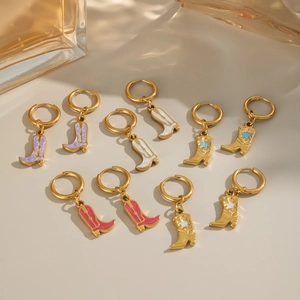 Detailed macro view of colorful enamel cowboy boot charms on 18K gold plated hoop earrings