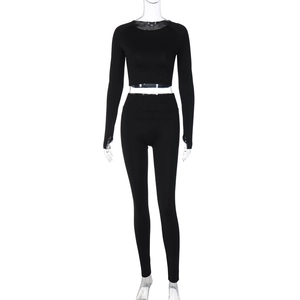 Detail of black long sleeve crop top and high waisted tight yoga pants on mannequin