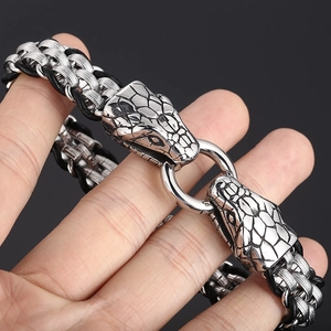 Snake head stainless steel braided bracelet with black leather elements on wrist