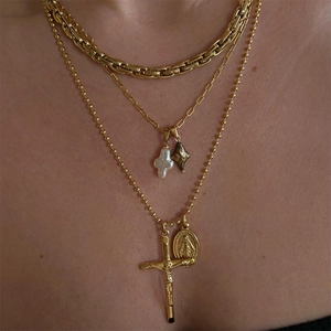 Three-layer gold necklace set featuring pearl cross and religious medallion pendants