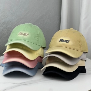 Stack of vintage washed baseball caps with Heart embroidery and distressed brim details
