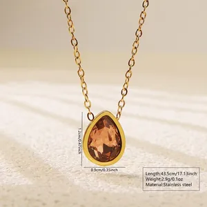 Detail of golden stainless steel necklace with pear-shaped brown stone pendant and sizes