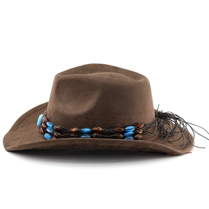 Detail of brown suede cowboy hat featuring blue beaded band and black tassel accents