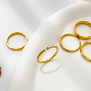 Set of minimalist gold titanium steel rings with cubic zirconia for stacking